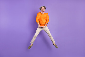 Fototapeta na wymiar Full length photo of mature man happy positive smile have fun jump up isolated over purple color background