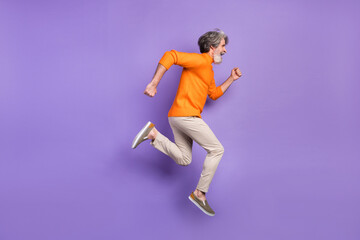 Fototapeta na wymiar Full size profile side photo of mature man go walk run jump hurry sale isolated over purple color background