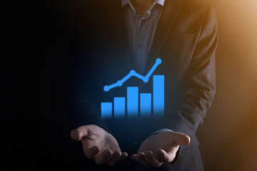 Businessman man holding a graph with positive profits growth. plan graph growth and increase of...