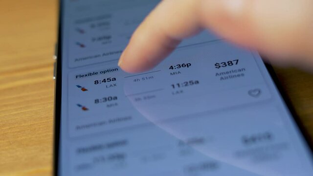 Buy Plane Tickets Online. Close-up of the Phone Screen and Female Fingers. 
