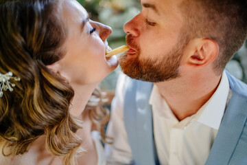 The bride and groom have fun and eat french fries. snack for newlyweds.