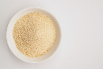 view from above on bowl filled with brown sugar on white table