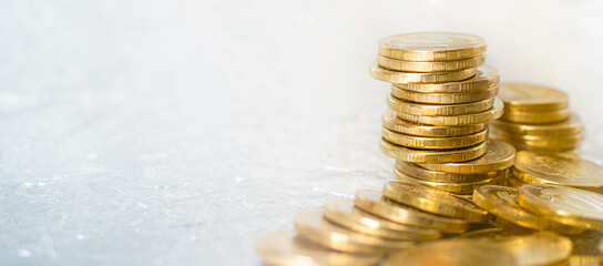 Background golden pile of different gold coins on the table