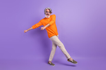 Fototapeta na wymiar Full length profile side photo of mature man happy positive smile carefree have fun dance party isolated over violet color background