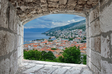 View from stone window on Senj town, Croatia. View from Nehaj Fortress, fort on the hill, Velebit, Croatia.
