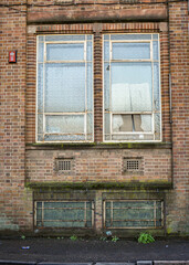 Fototapeta na wymiar Broken window in brick building