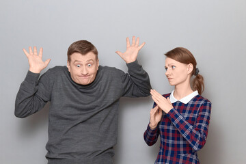 Portrait of couple talking, quarrelling, arguing emotionally