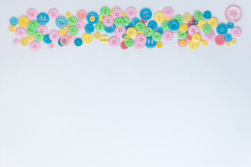 Colored buttons located at the top on a white background. A place for text. Green, blue, yellow, pink buttons.