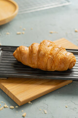 freshly baked croissants on black plate. French and American Croissants and Baked Pastries are enjoyed world wide.