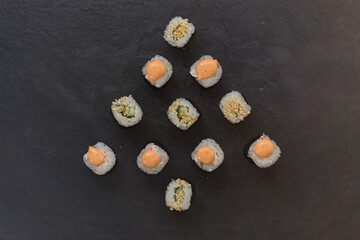 mini rolls are lined with Christmas trees . Rice, cucumber, sesame, avocado, nori. view from above