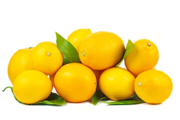 Pile of ripe lemons with green leaves isolated on a white background