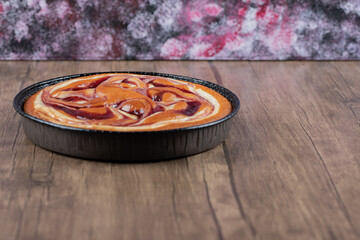 Strawberry pie in a black metallic pan on the table