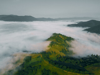 Sea of clouds and Picturesque Mountains Above. Beautiful Carpathians at early winter or Autumn Aerial View