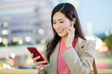 woman use ear buds outdoor