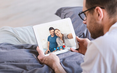 Man making video call with friends using tablet