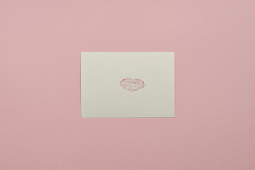 Handmade postcard with mark of lips on pink background