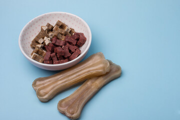 dog food in a bowl and a bone for brushing your teeth. Animal feeding