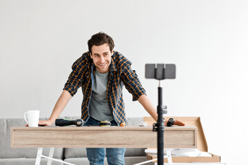 Modern builder, handyman blogger records video for repair and assembling furniture