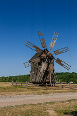 Fototapeta na wymiar Old windmill on blue sky background