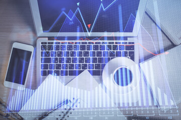 Stock market chart and top view computer on the table background. Double exposure. Concept of financial analysis.