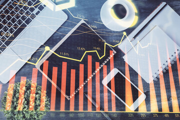 Double exposure of forex chart hologram over desktop with phone. Top view. Mobile trade platform concept.