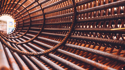 reinforcement concrete and plastic orange net. Inside view of rebar for reinforced hole in the ground. Texture background net metal red