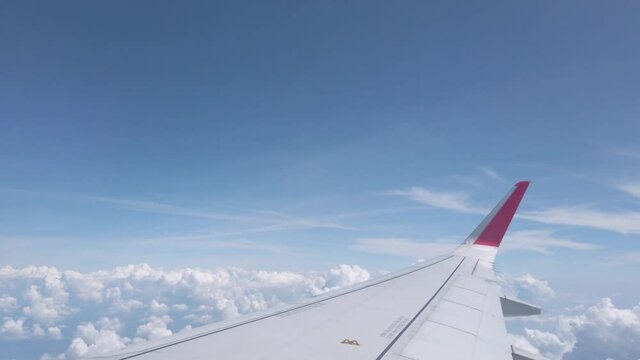 Sky from airplane with wing fly over cloud in summer sunshine day in Bangkok