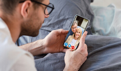 Man making video call with parents using smartphone