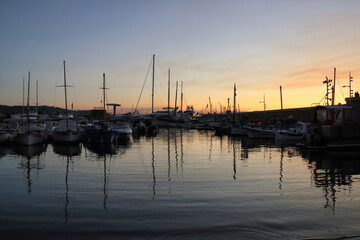 nautical vessel reflected in the water in port of saint tropez