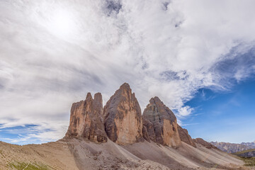 Famous three peak of Tre Cime di Lavaredo on the background of a beautiful sky. Italian Dolomites. South Tyrol, Italy