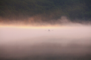 a rowing boat on a lake at sunset © uranos1980