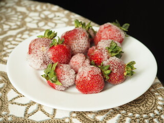 Frozen strawberry with ice crystals. Strawberries in winter