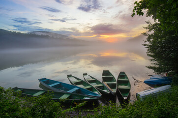 green boats on the lake at sunset