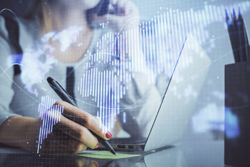 Multi exposure of woman hands typing on computer and business theme hologram drawing. Success concept.