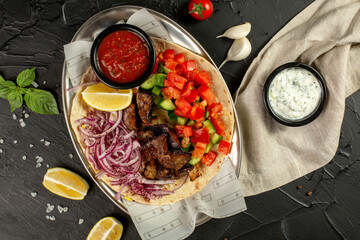 Kebap, roasted meat and vegetables on grill