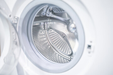 open door of an empty washing machine close up