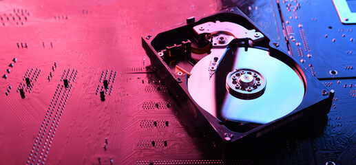 Computer Hard disk drives HDD , SSD on circuit board ,motherboard background. Close-up. With...