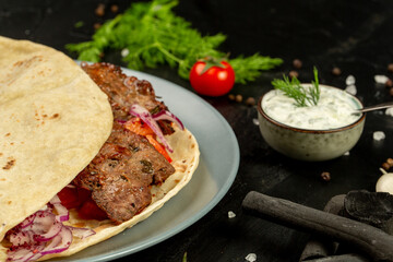 Kebap wrapped in a very thin pita or lavash 
