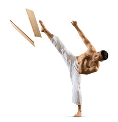 Karate man breaking with leg wooden board Isolated