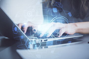 Double exposure of woman hands typing on computer and social network theme hologram drawing. People...