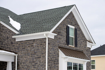 house wall faced with natural stone tiles