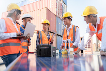 Engineers discussion and design of alternative energy,solar panels,wind turbine model at the warehouse industry.renewable and sustainable development for green energy concept. © Yingyaipumi