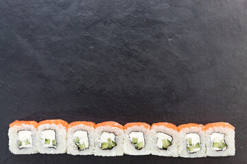 rolls are laid out on a stone platter at the bottom. place for text at the top. foodphoto