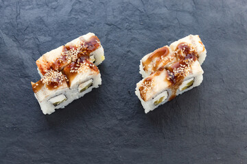 rolls with teriyaki sauce. Rolls and sushi. Avocado, rice, eel. Eel rolls. serving a dish