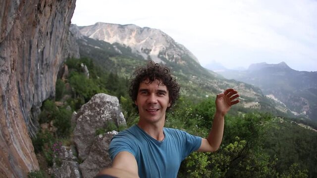 A man takes a selfie against the backdrop of a beautiful mountain valley and rocks, A man travels through the picturesque places of the world, Turkey Rocks, Rock Climbing in Turkey.