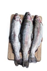 Fresh raw rainbow trout fish on wooden board isolated on white