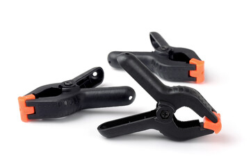Three black plastic spring clamps
