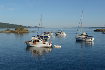 Fototapeta na wymiar Boats in the anchorage at Princess Bay, Portland Island, British Columbia, Canada
