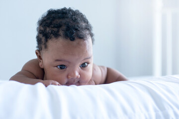 3 months adorable Mixed-race baby girl on the bed in her room