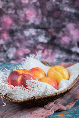 Yellow red peaches isolated on a piece of white burlap